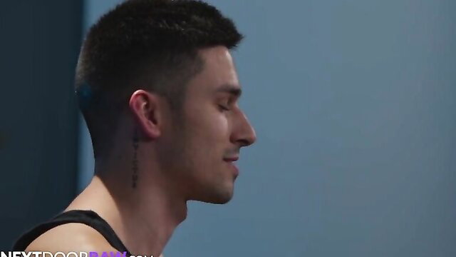 Kane Fox profile view, handsome hunk with neck tattoo in tank top