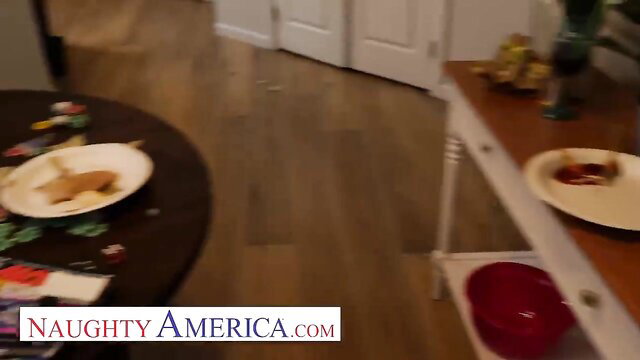 McKenzie Lee at table with plates in Naughty America scene