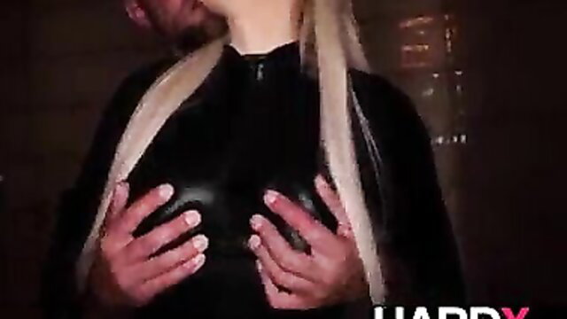 Blonde in latex catsuit groped by man, fake tits teased