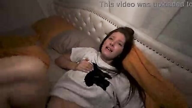 Brunette amateur babe lying on bed in t-shirt, legs spread teasing pussy