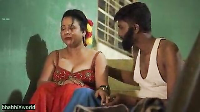 Indian bhabhi in red blouse skirt seduces bearded man, deep cleavage