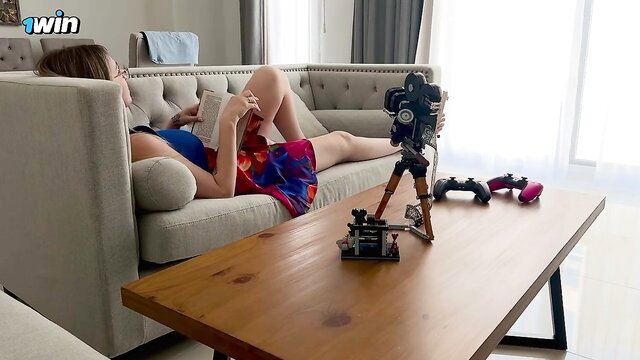 Russian mom Alina Rai lounging sexy on sofa in floral mini skirt