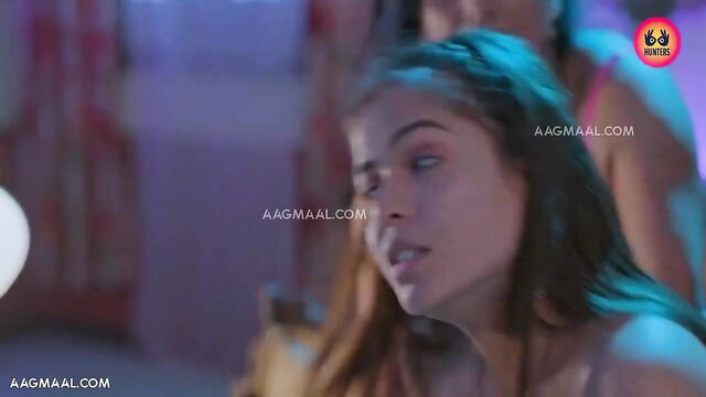 Seductive young Indian beauty with glossy lips in dim blue light