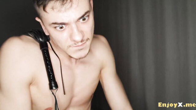 Hot male model with riding crop in kinky BDSM pose, Catherine Knight XXX