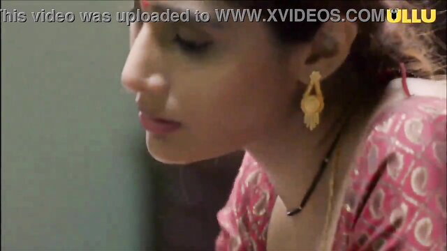 Closeup of sexy Indian lesbian in pink saree with gold jewelry