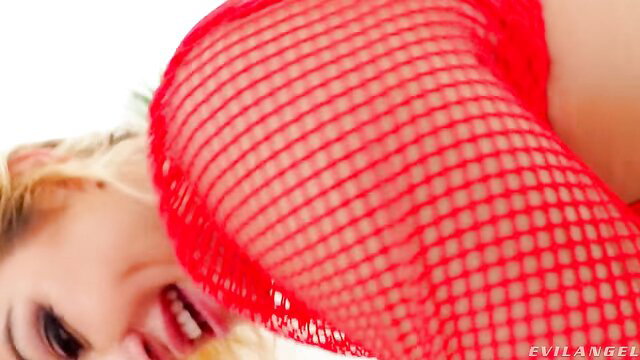 Cherry Kiss smiling in red fishnet lingerie, sexy closeup