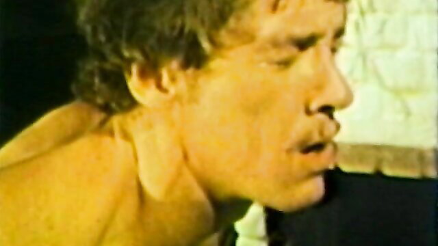 Vintage gay closeup of muscular man's intense face and neck in retro XXX peepshow