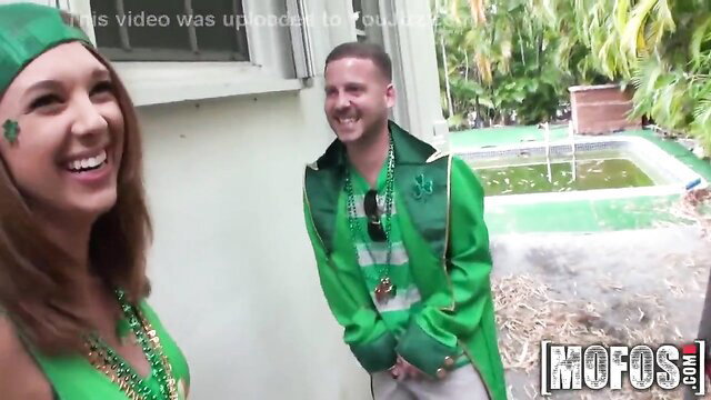 Sexy St. Patricks Day party with busty brunette and fit guy in green outfits