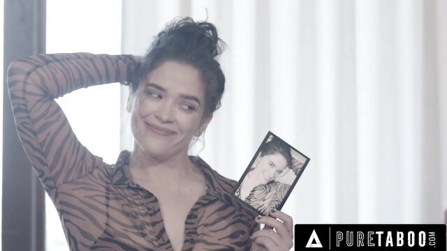 Victoria Voxxx holds photo in zebra top, Pure Taboo picky wife scene