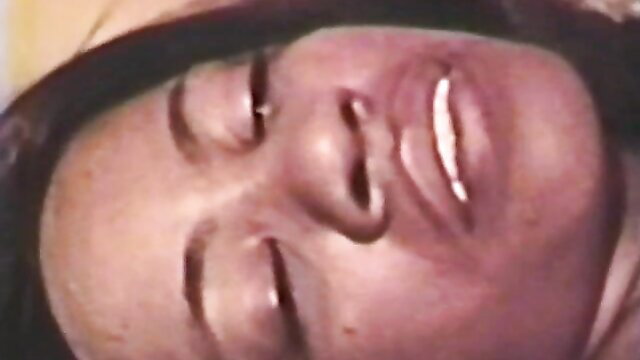 Closeup of smiling Asian woman with glossy lips in classic XXX peepshow