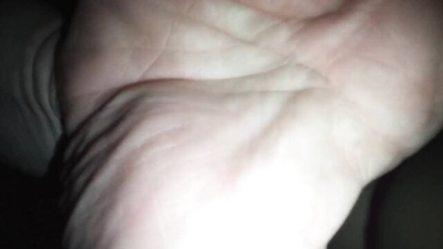 Closeup of pale woman's wrinkled asshole in dim light