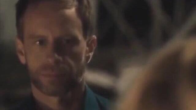 Closeup of handsome mature man with stubble in dim-lit intimate scene