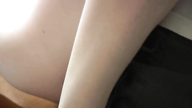 Skinny babe legs spread on desk in white skirt black top