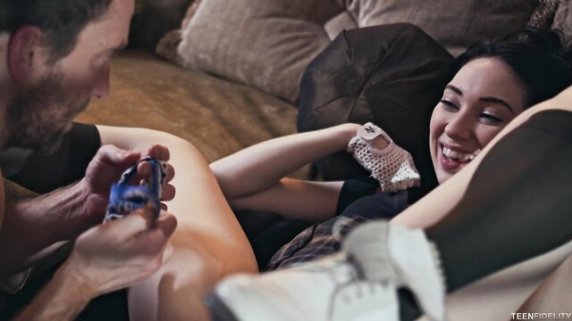 Aria Alexander smiles playing games with man on couch in sexy outfit