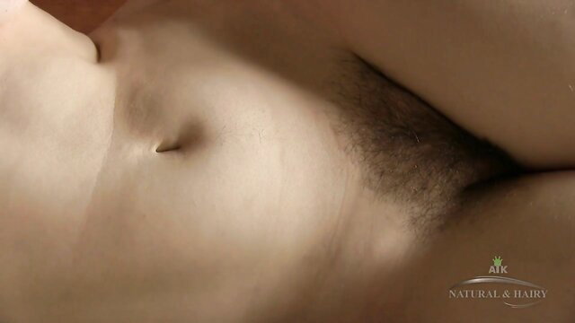 Closeup of hairy pussy under sheer white panties, natural bush tease