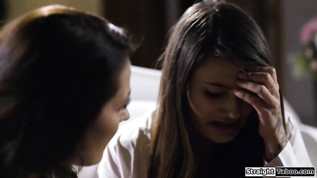 Brunette stepaunt comforts emotional teen niece on bed in taboo talk