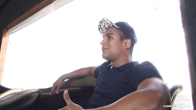 Muscular Latino dude in cap thumbs up on boat, Carne Del Mercado