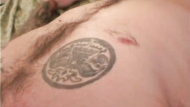 Hairy white guy with chest tattoo stroking cock in amateur solo vid