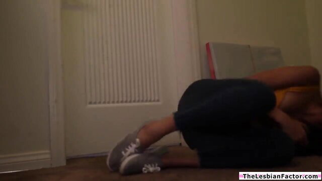 Marica Hase in lesbian pose, gray sneakers, black leggings, yellow top