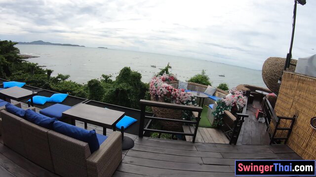 Thai swinger beach resort deck with blue loungers and sea view