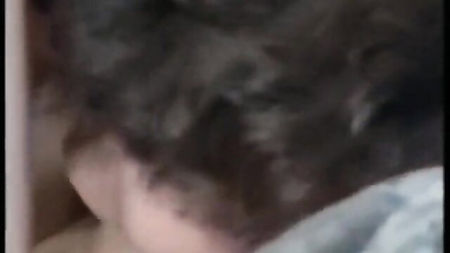 Blurry classic porn thumbnail of woman with dark hair in low-cut top