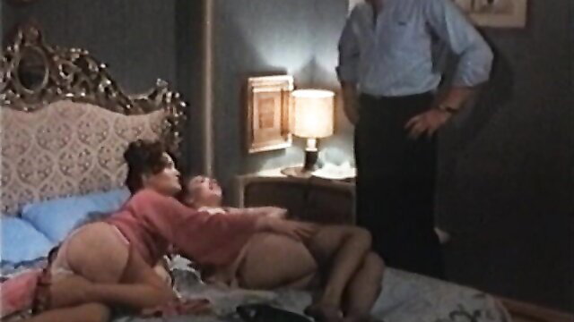 Vintage 1981 Teenage Emanuelle threesome with two busty brunettes on bed