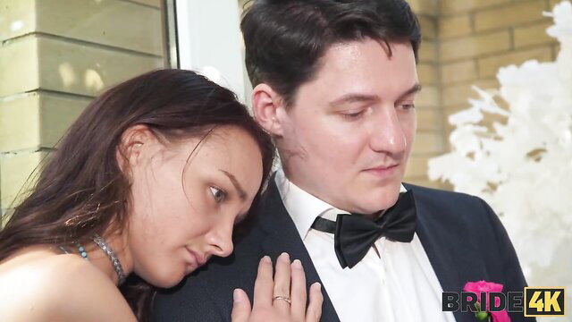 Arty and Alice with sexy bride leaning on groom in tuxedo, wedding smut