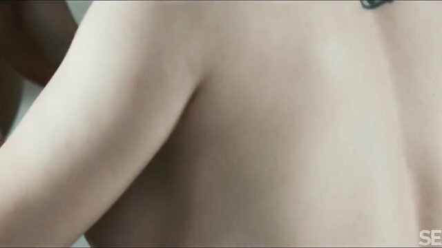 Sata Jones topless back view with green tattoo, sexy nude pose