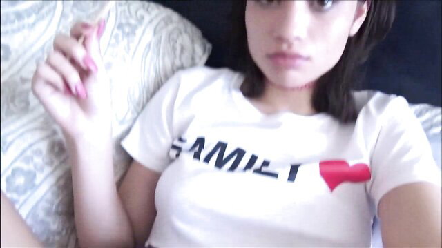 Liv Wild in FAMILY tee, seductive selfie on bed, teasing look