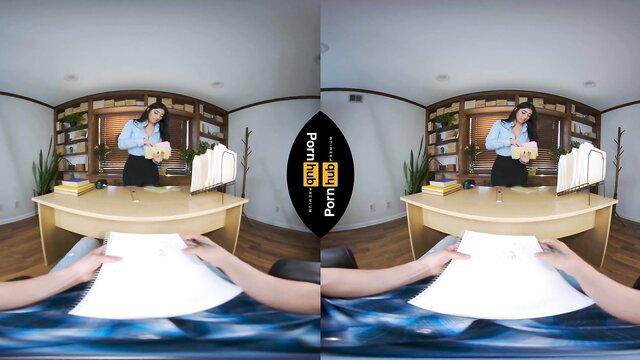 Violet Myers in tight blouse bending over desk in Spanish Lessons