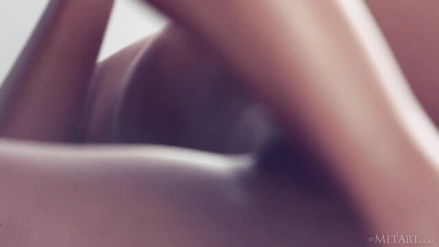 Artistic nude woman bent over with round ass and soft curves exposed