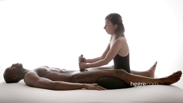 Petite white girl massages huge black man's erect cock in erotic session