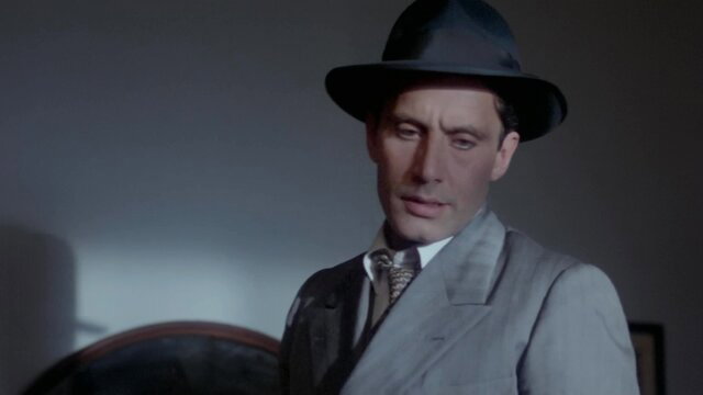 Handsome suited man in fedora, intense gaze, classic Hollywood star vibe