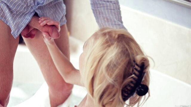 Skinny blonde toddler gripping man's erect penis in bath