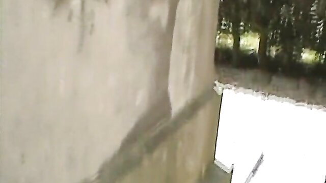 Mature Dutch MILF Kimberly outdoors by wall, teasing pose