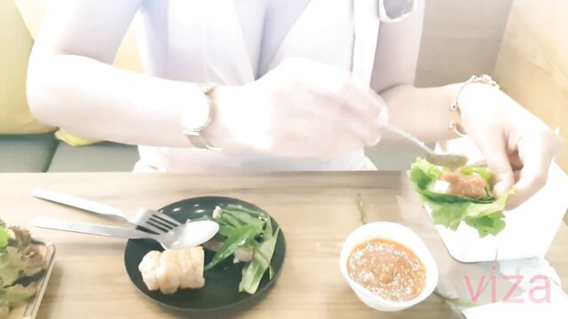 Thai nurse in white uniform eating kebab at table, big boobs tease