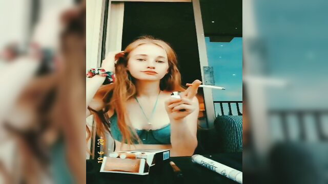 Sexy redhead milf smoking cigarette on balcony in lingerie