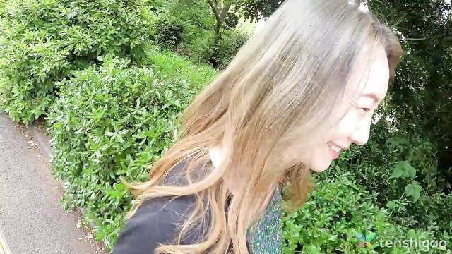 Busty Japanese milf housewife smiling outdoors, long blonde hair