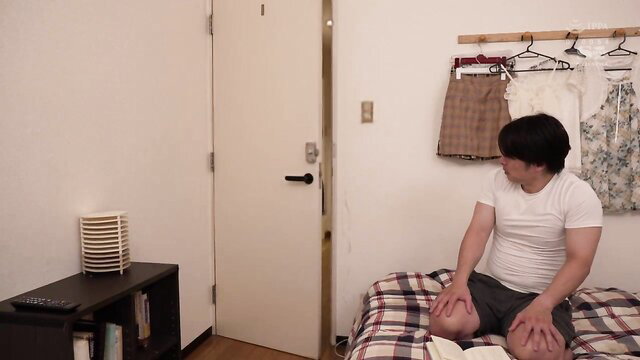Tsukasa Aoi's older sister in JAV, kneeling on bed in tight shorts