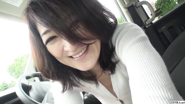 Smiling Japanese MILF in car, public exposure tease