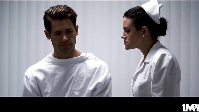 Nurse Penny Barber eyes patient Giovanni in tense hospital scene