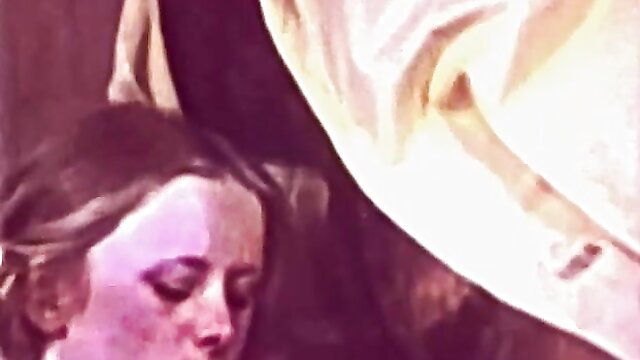 Retro blonde with heavy makeup in yellow top, closeup face view