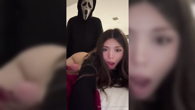 Asian girl shocked by Ghostface grabbing her at Halloween party