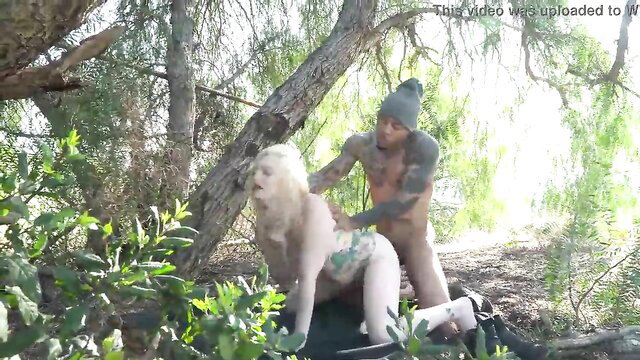 Tattooed guy cums on nude blonde nymph outdoors in forest