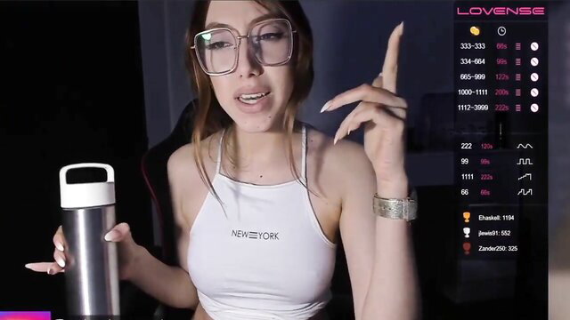 Sexy Asian gamer girl in crop top holds tumbler on stream