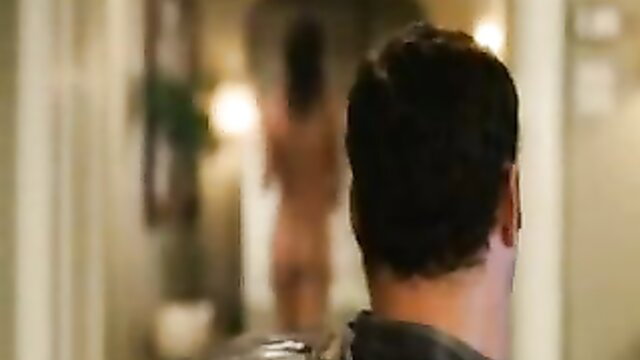 Nude brunette woman viewed from behind in steamy bathroom mirror scene