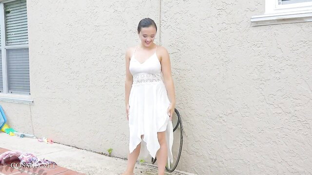 Roxy Bloom in sexy white lace dress, smiling outdoors