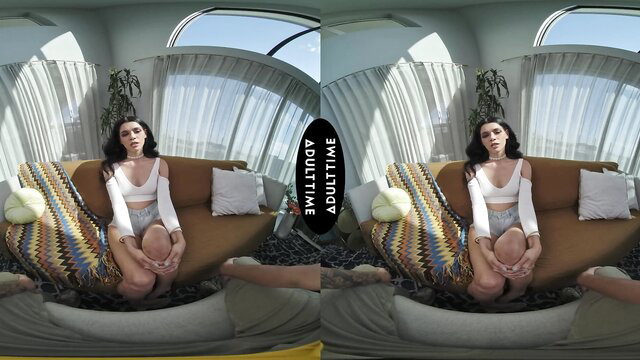 Harley Haze petite brunette sits legs spread on couch in VR POV