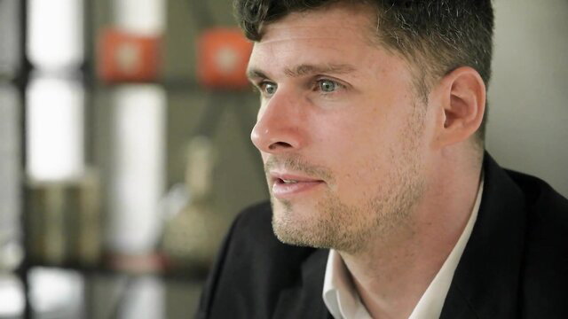 Handsome European man in suit, closeup profile view