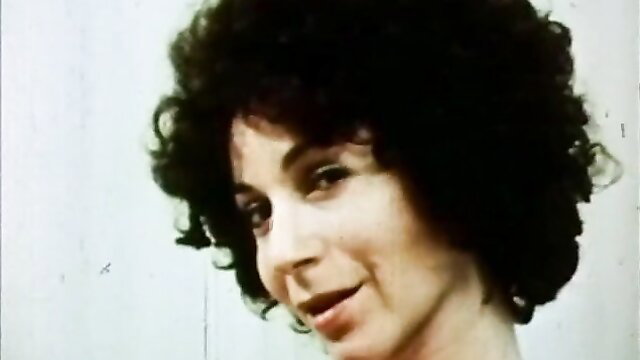 Vintage 1970s brunette with big afro smiles in underground kink flick